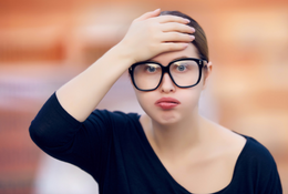 Woman slapping her forehead in dispair