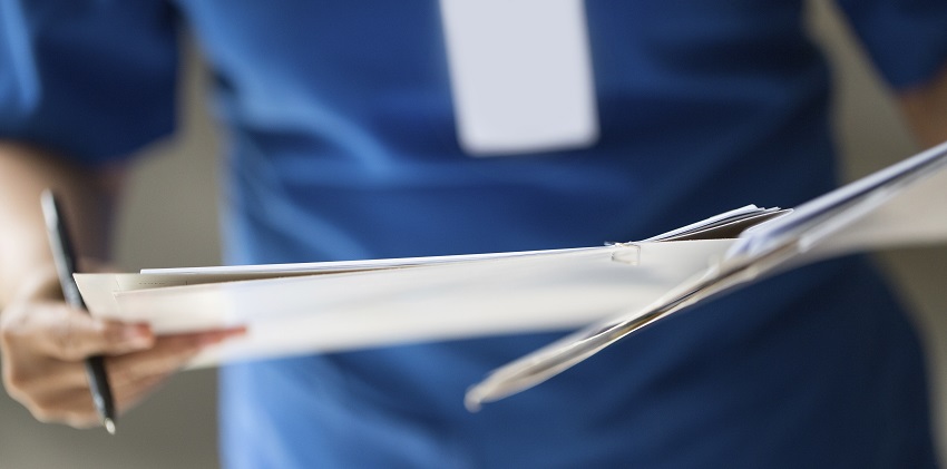 Nurse checking patient document